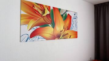 A painting of flowers on a white wall.