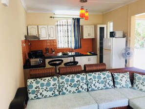 Villa | Living area | 32-inch TV with satellite channels