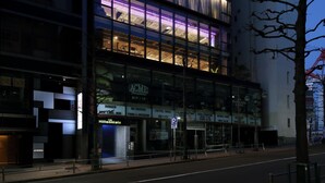 A modern building with multiple floors, large windows, and a prominent entrance. - The Millennials Shibuya (Tokyo)