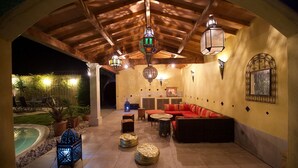 An outdoor patio with a pool, seating area, and decorative lanterns. - Hacienda : 220m2 villa for 12 people with swimming pool, 5 minutes from the beach (Vic La Gardiole)
