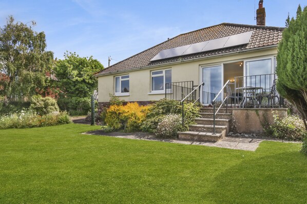 A two-story house with a front garden, a staircase leading to the entrance, and a visible door. - Meadow View, Blue Anchor (Blue Anchor)