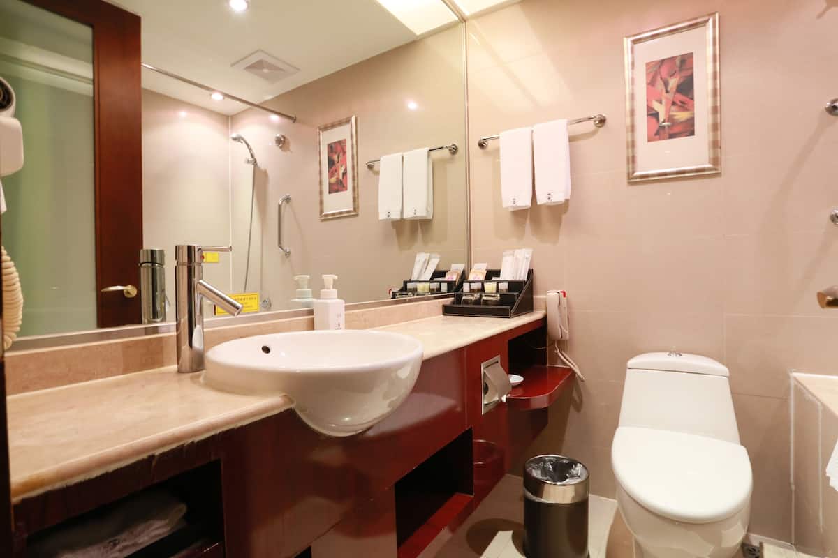 executive suite, 1 bedroom, 2 bathrooms, city view | bathroom | shower, free toiletries, hair dryer, slippers