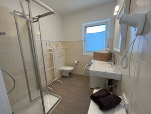 Shower, hair dryer, towels, soap