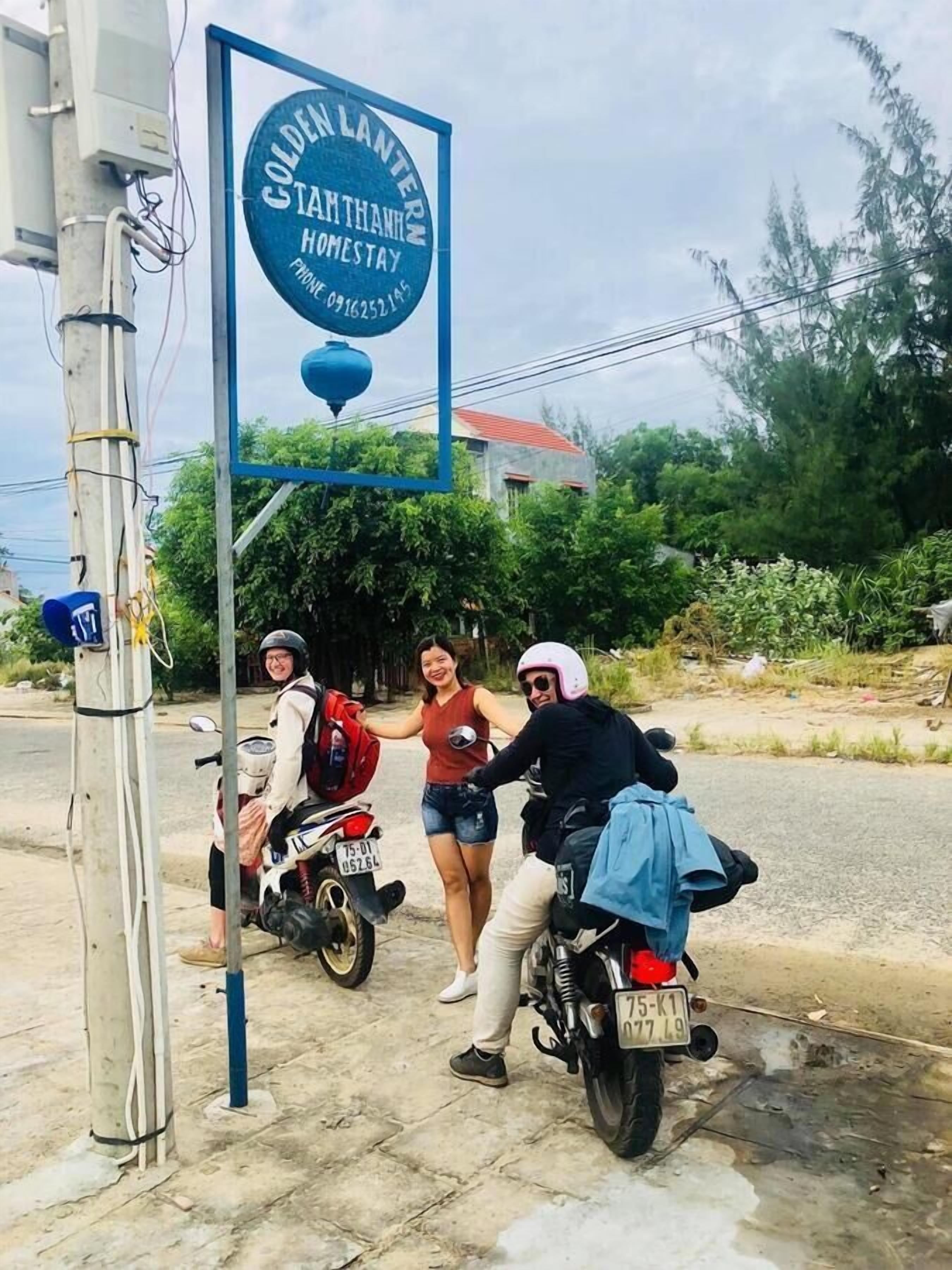 A sign for 'Coldelan Lantern Homestay' with a contact phone number.