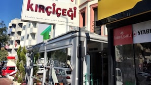A building with a sign for 'Kirkeci Hotel' and a storefront for 'Faber-Castell'. - Imerhan Otel (Kusadasi)