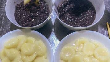 Three bowls of food on a metallic surface.