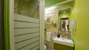 A bathroom with a shower, toilet, and sink.