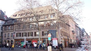 A street scene with a building featuring multiple windows and a signboard. - lacour ac 160m2 city center  4br3bth (Colmar)