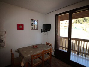 Enjoy a quiet meal for two in this cozy dining area with a view of the surrounding neighborhood.