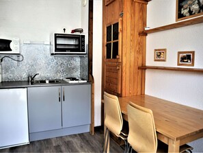 Enjoy meals in this cozy kitchen with oven, countertop, and storage cabinet.