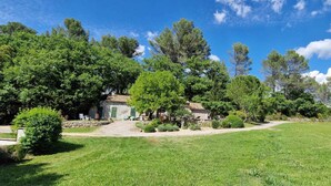 A rural property with a stone house, surrounded by lush greenery and trees. - Camfier self-catering cottage (TOURVES)