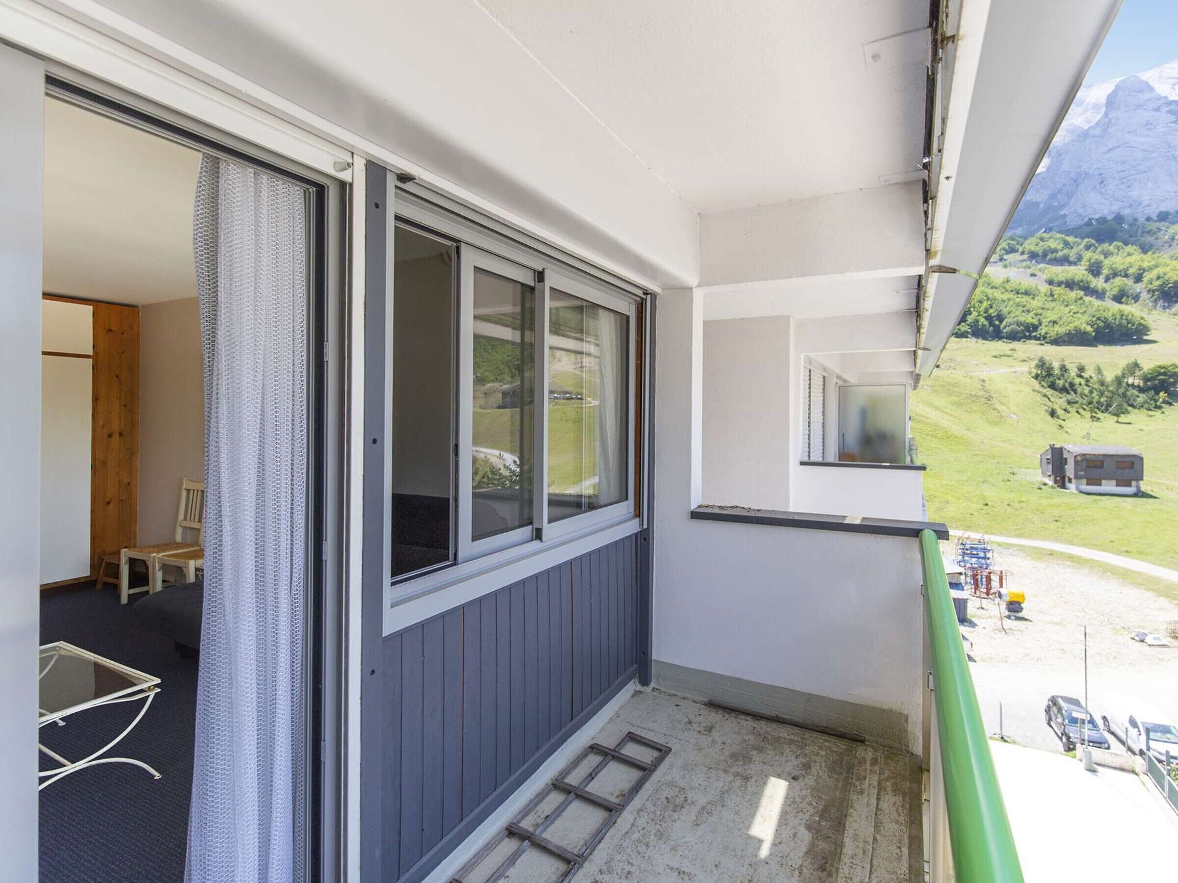 A balcony with a view of a mountainous landscape.