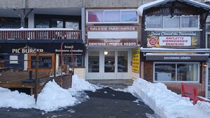 A storefront with signs for 'Galerie Marchande', 'Pic Burger', and 'Souvenirs Génépi'. - Cozy 5-person studio near slopes, parking included (La Mongie)