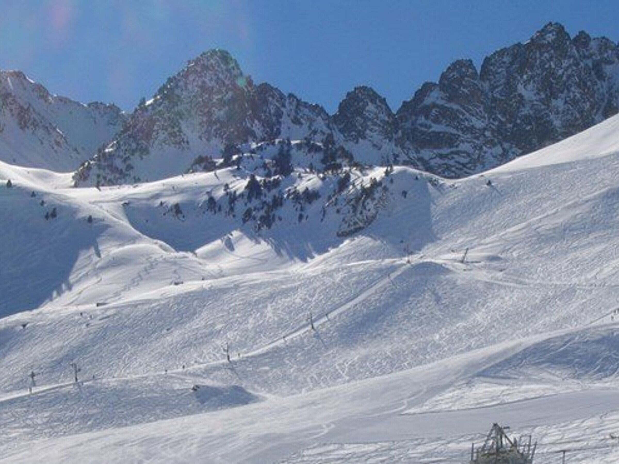 A snow-covered mountain with ski slopes and a ski lift.