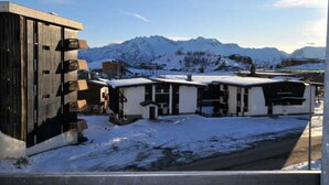 A snow-covered building with a mountain backdrop.