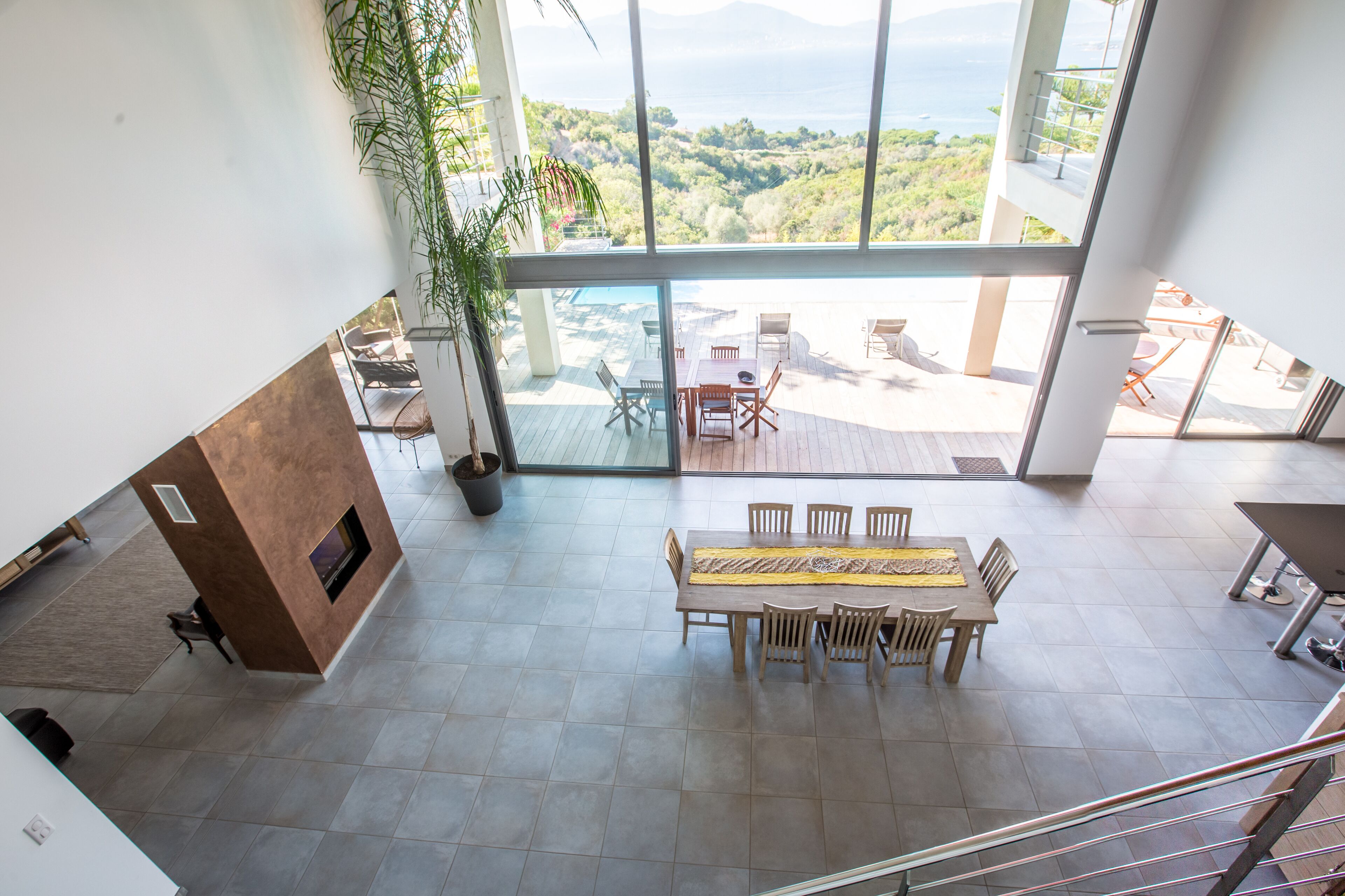 A spacious interior with a large dining area, a fireplace, and a view of the outdoors.