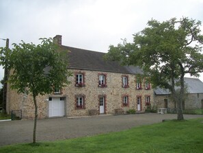 Traditional stone building with a central entrance and evenly spaced windows.