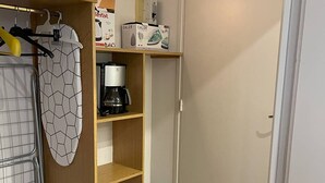 A compact kitchen with a coffee maker, a hanging oven mitt, and storage boxes. - T2 Apartment for 5 in Cauterets (Cauterets)