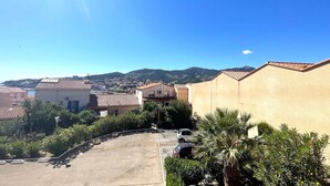 A residential area with buildings, a parking lot, and a clear sky.