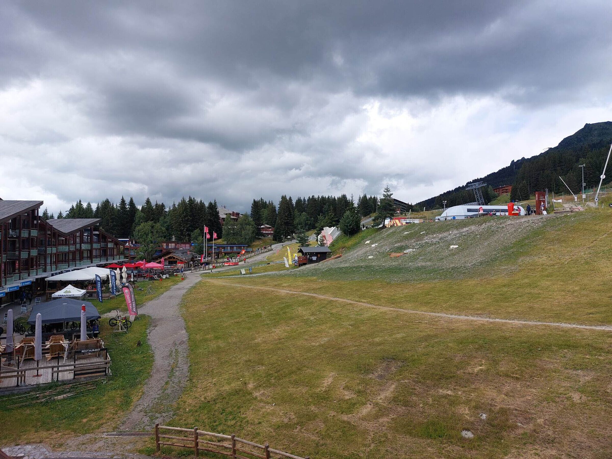 A ski resort with a restaurant, a ski lift, and a mountain backdrop.