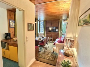 A cozy interior with a dining area, kitchen, and seating space.