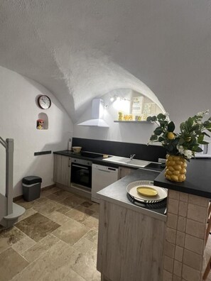 A kitchen with a central island, a sink, and a stove.
