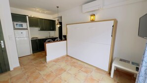 A compact kitchen with a microwave, stove, and cabinets. - Apartment Studio located 50m from the beach of Canyelles Petites, Roses (Rosas / Roses)