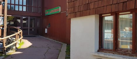 Un edificio con un letrero que dice "LES LAUZIERES" y una escalera de madera que conduce a una puerta.
