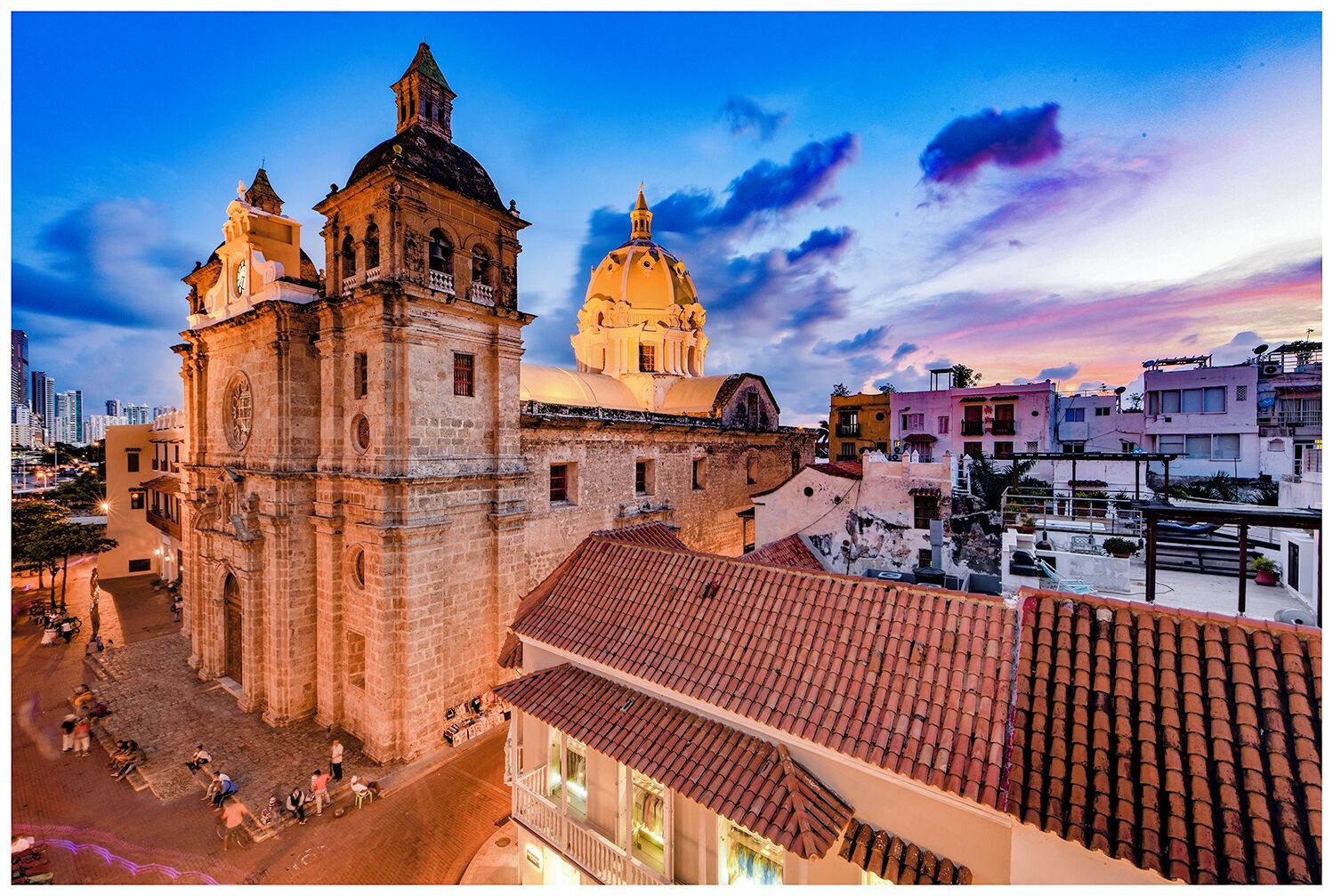 A historic building with a prominent bell tower and a large dome, surrounded by residential buildings.