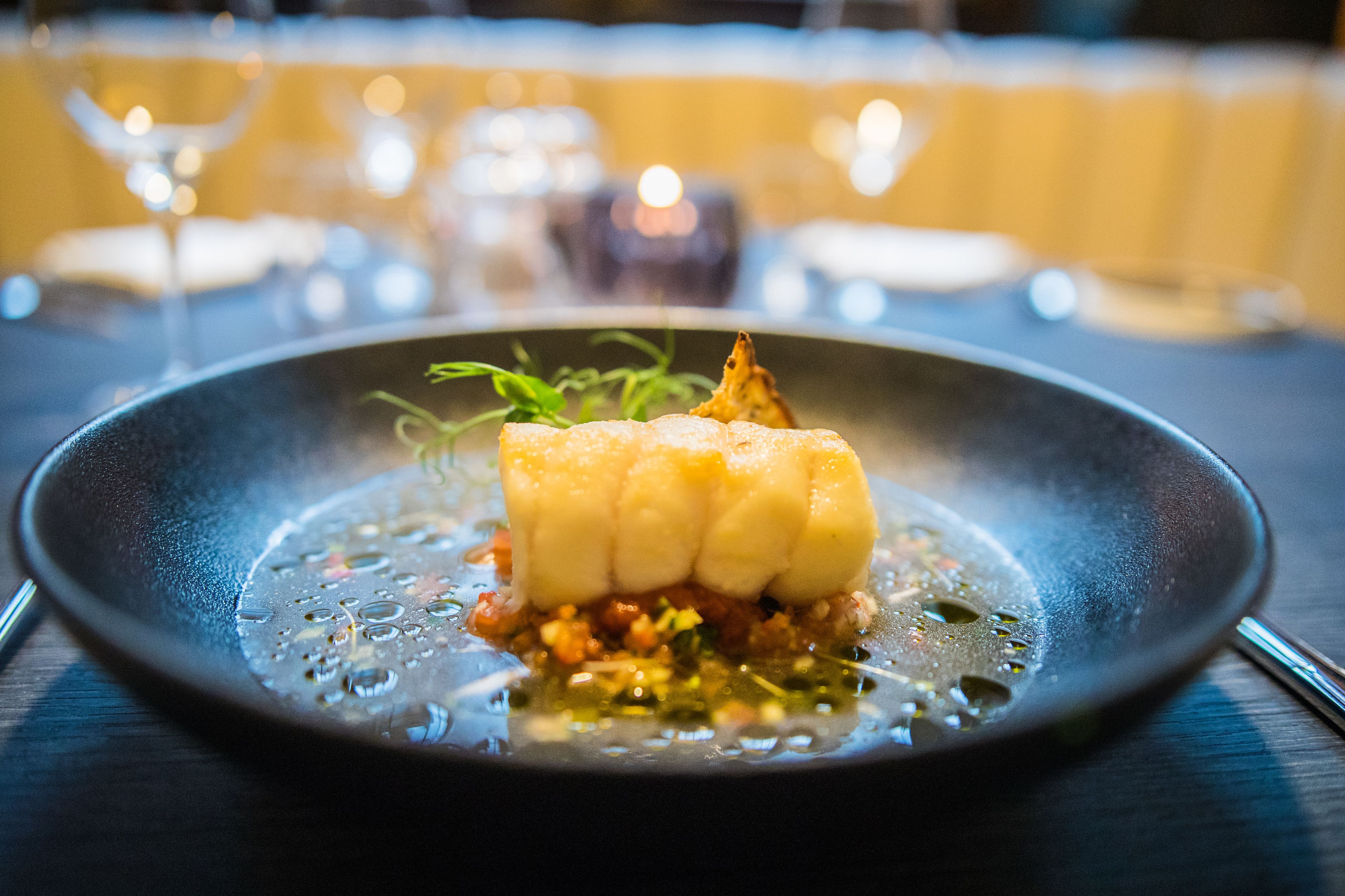 A plate of food with a creamy texture and a garnish on top.
