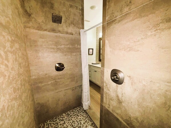 A small, enclosed shower area with a shower curtain, a towel rack, and a mirror on the wall. - Luxury 8BR Ocean Views, Pool & Heated Spa, Walk to the Beach! 360 Views from Top (St. Augustine)