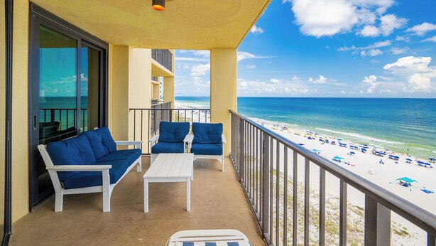 A balcony with a view of the beach, white furniture, and a railing. - Azure Luxury | P3 3092 | Oceanfront Gem! (Orange Beach)
