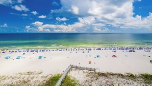 A beach with a wooden walkway leading to the shore, clear blue sky, and calm sea. - Azure Luxury | P3 3092 | Oceanfront Gem! (Orange Beach)