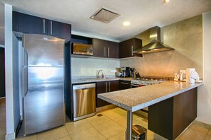 A modern kitchen with stainless steel appliances, a built-in dishwasher, and a granite countertop.