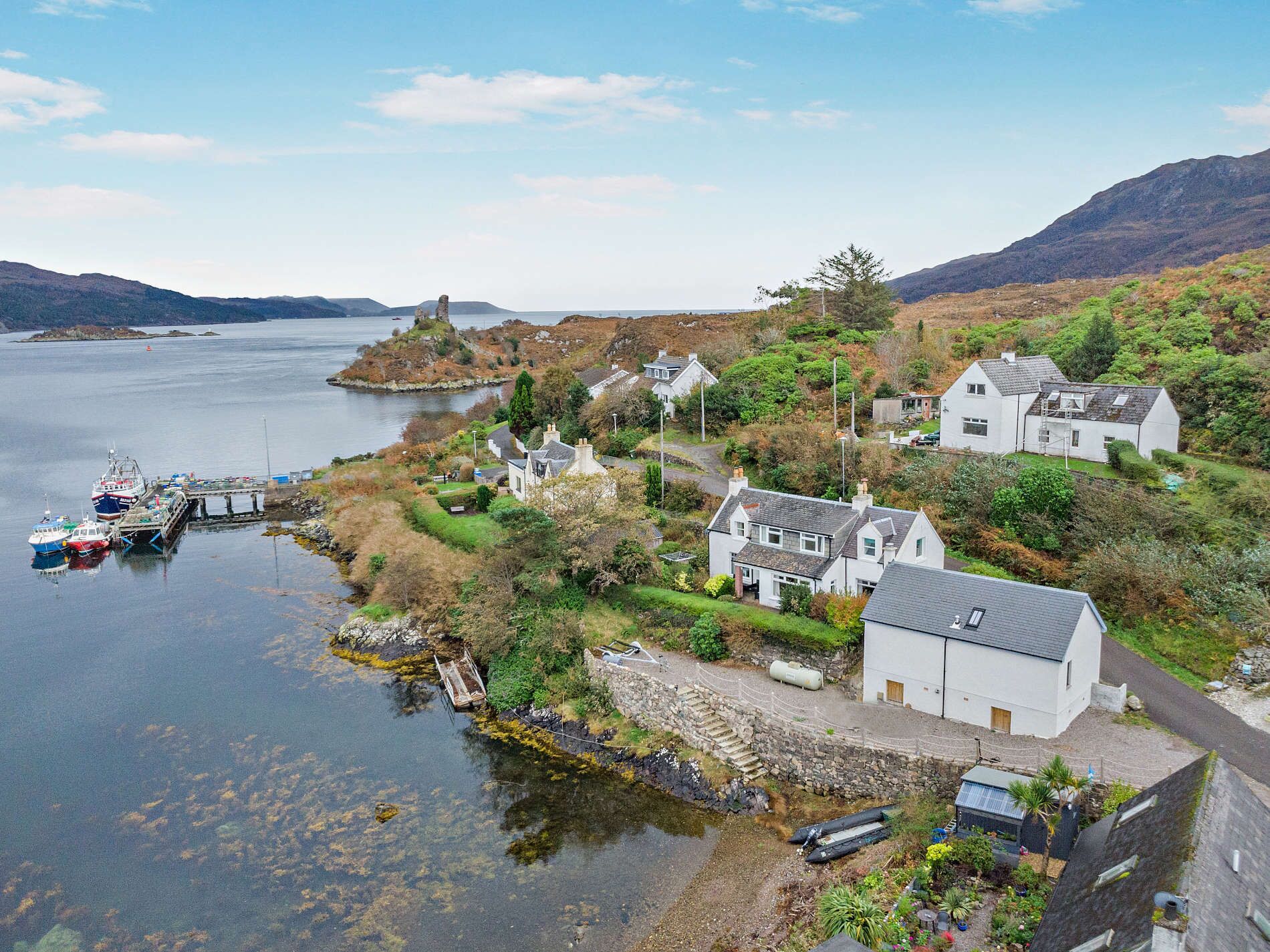A coastal village with houses and boats by the water.