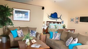 A living room with two sofas, a coffee table, and a wall-mounted fish decoration. - Roomy, Quaint, Studio Loft w/ Bay View - Central SD Location  (San Diego)