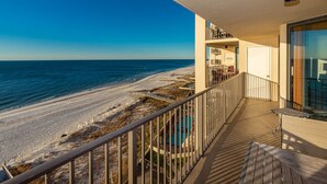 A balcony with a view of a beach and ocean. - See why this condo is in high demand! 3 Bedroom @ Phoenix IV (Orange Beach)