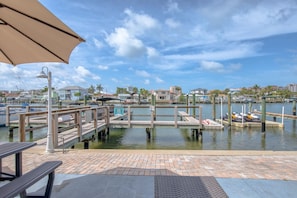 A marina with docked boats, a wooden pier, and a clear view of the water.
