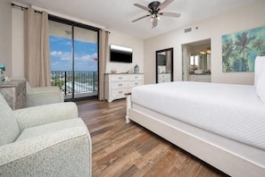 A hotel room with a balcony, a bed, a TV, a dresser, and a chair. - Phoenix 8 - 3 BR 2 BA - Condo on the BEACH! (Orange Beach)