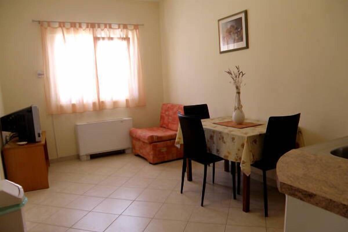 Apartment, 1 Bedroom (Ground Floor) | Living area | Flat-screen TV