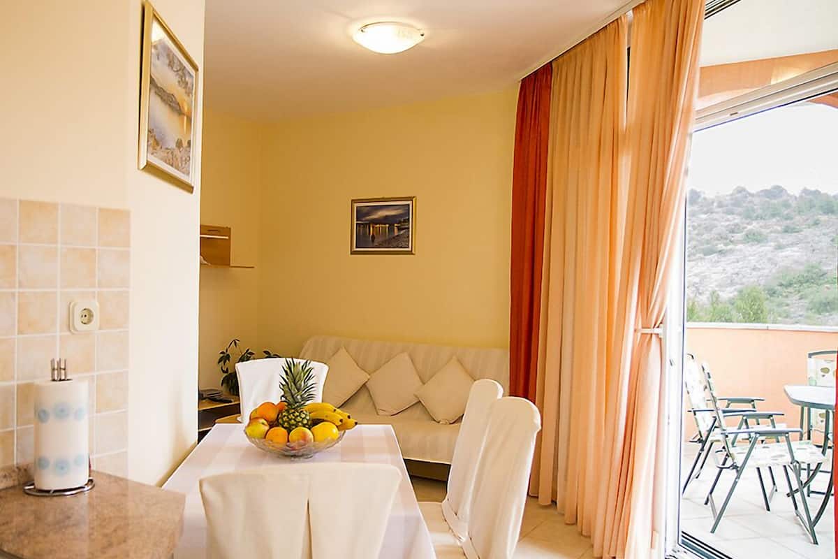 Apartment, 1 Bedroom, Balcony, Sea View | Living area | Flat-screen TV