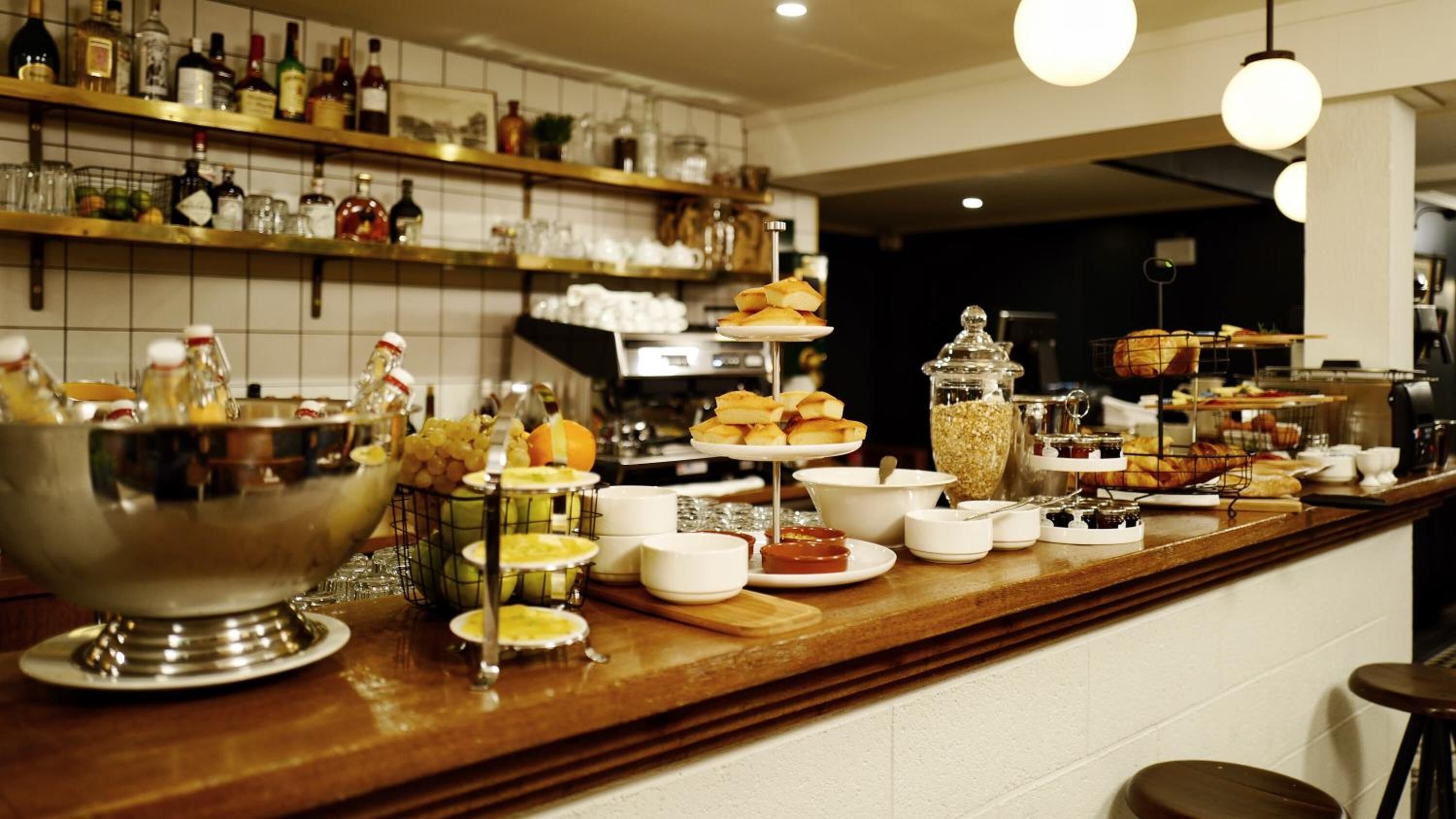 A buffet setup with various food items and condiments.