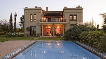 Outdoor pool, a heated pool, pool umbrellas, pool loungers