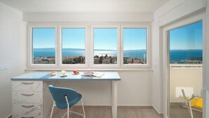A modern kitchen with a large window overlooking a coastal view. - Apartments 4 You in Split (Split)