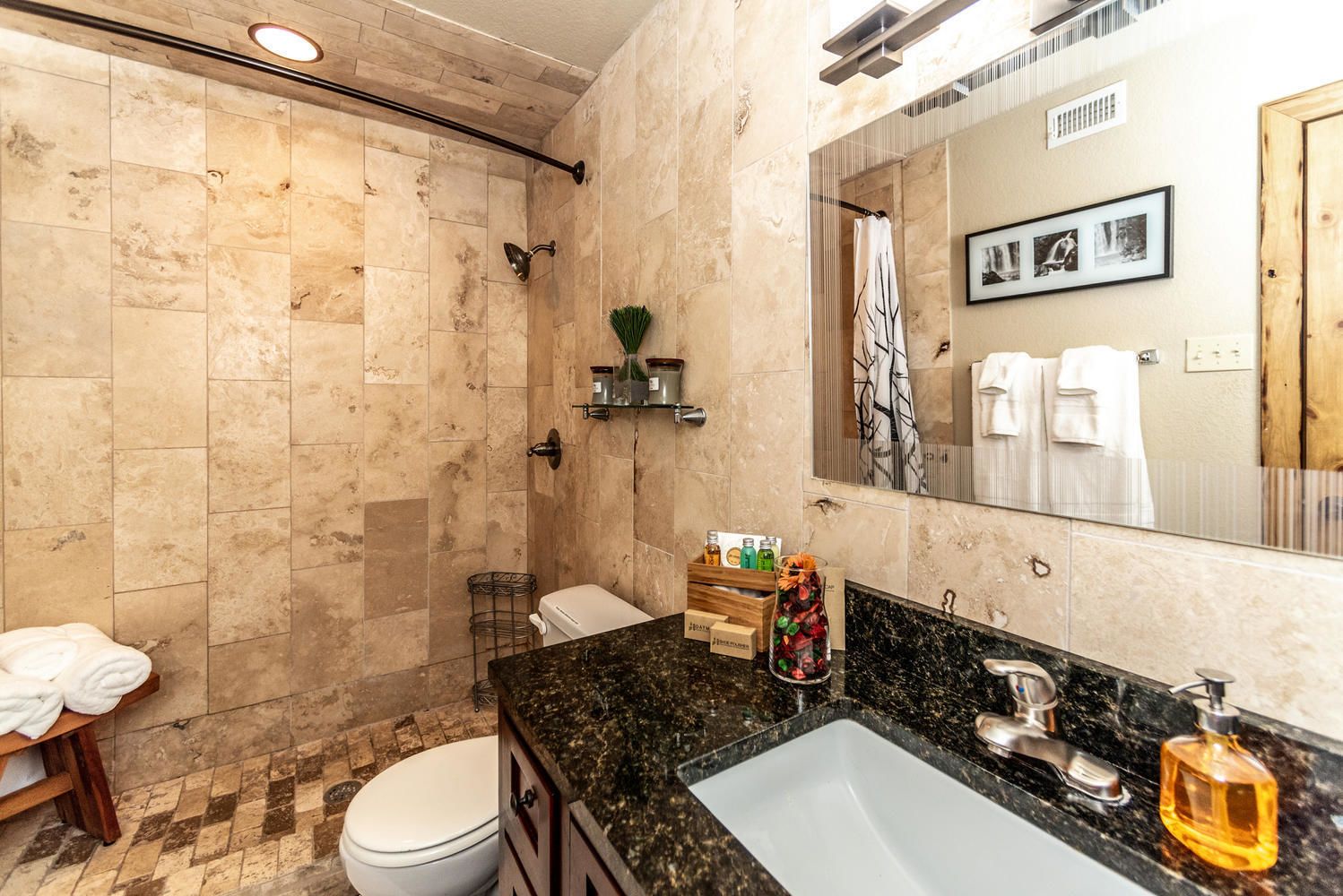 Un baño moderno con ducha, inodoro y lavamanos.