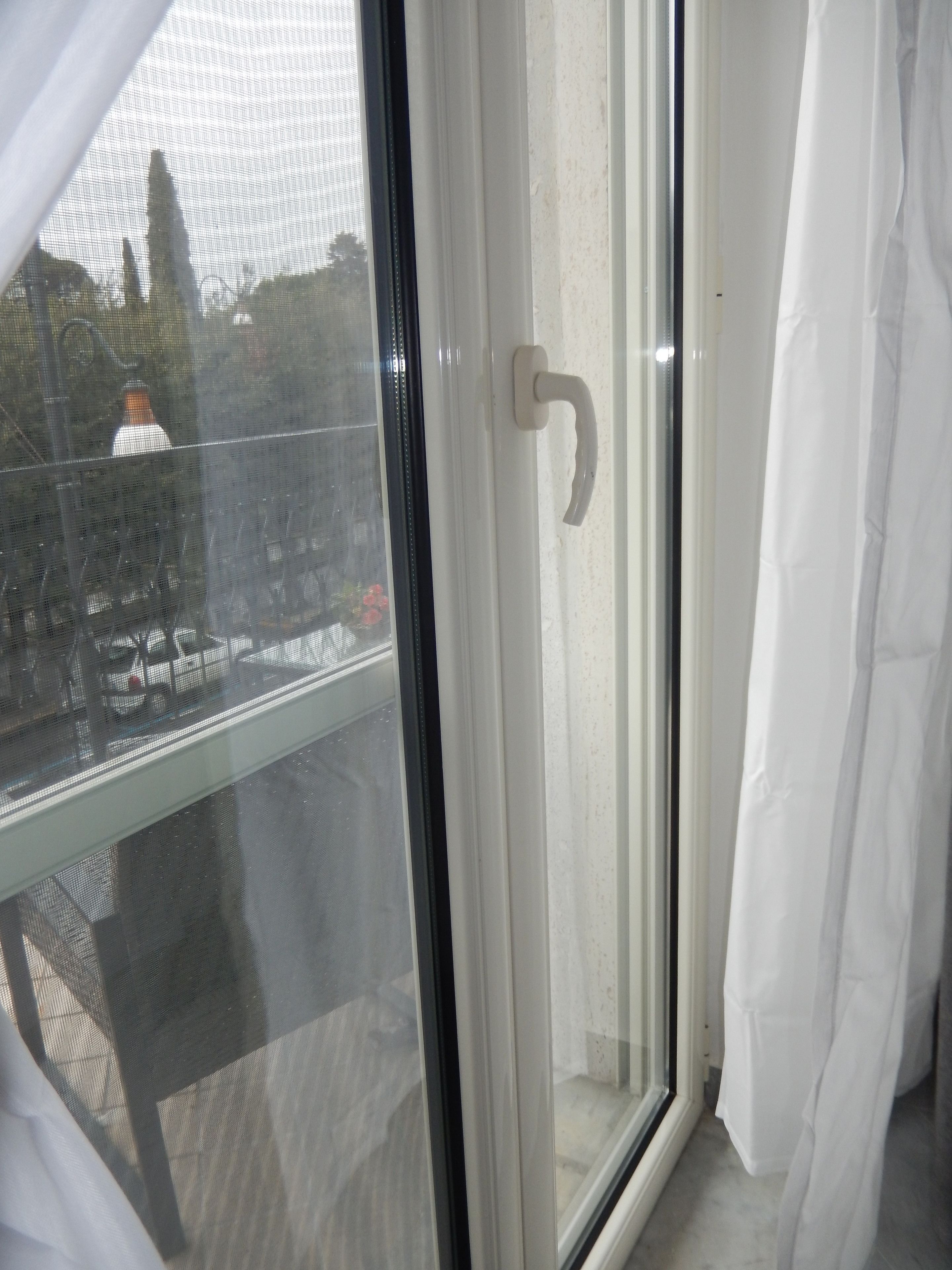 A room with a sliding glass door leading to an outdoor area.