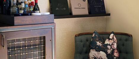 A bar area with bottles and a shelf with branded boxes.
