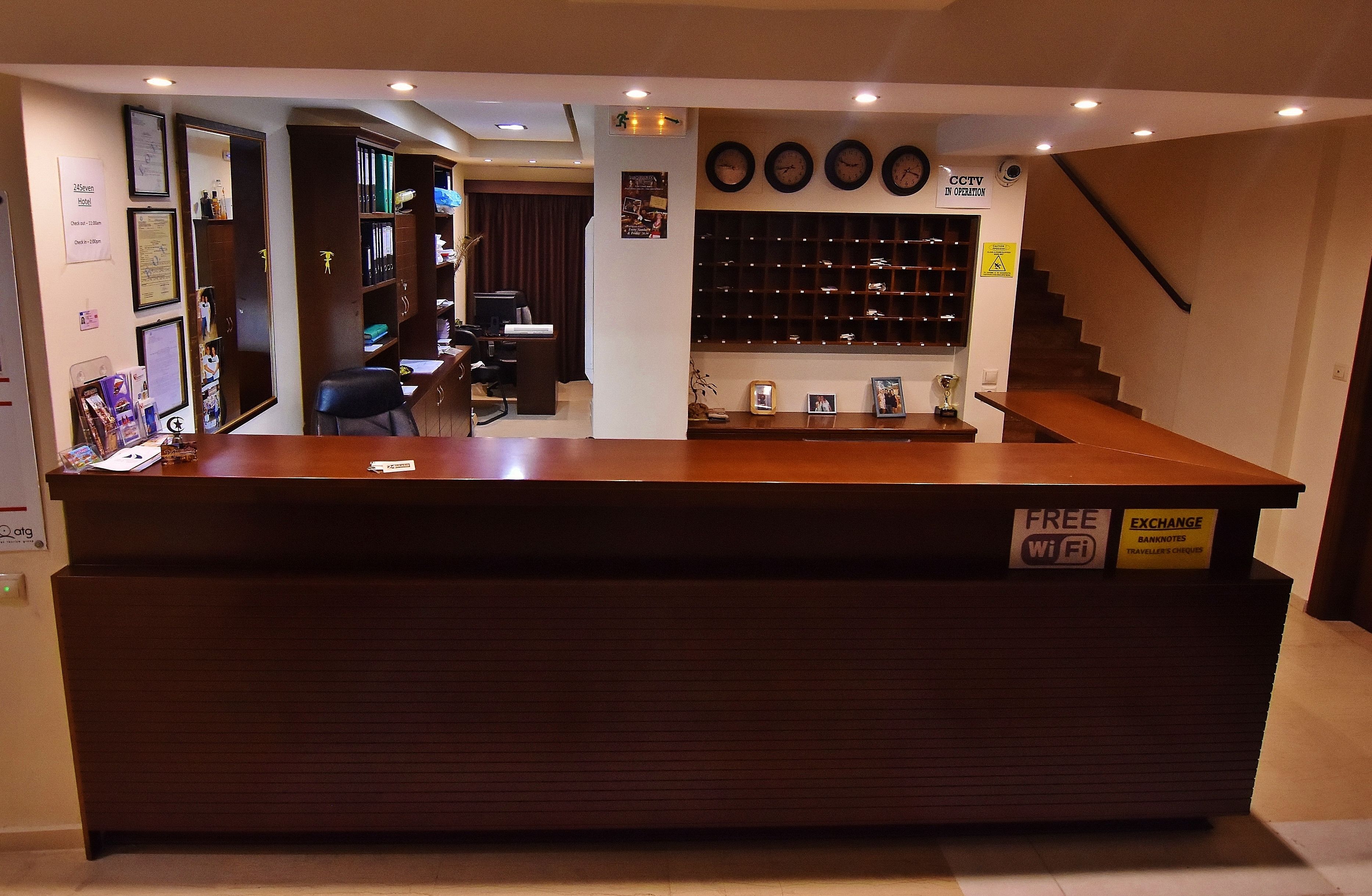 A reception desk with a sign offering free WiFi and exchange services.