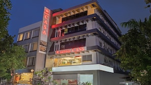 A multi-story hotel with a prominent 'HOTEL CASA' sign, featuring a modern architectural design with balconies and large windows. - Hotel Casa (Vadodara)