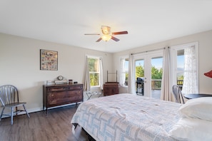 A bedroom with a bed, dresser, chair, and a ceiling fan. - Shenandoah mountain view home King bed StarLink EV port river access 90 min DC  (Bentonville)